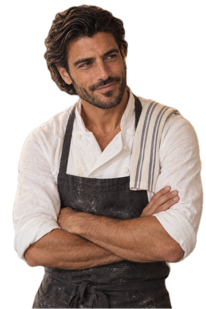 Marco, forty-five, arms folded in his white chef's jacket and charcoal apron, smiling toward his page